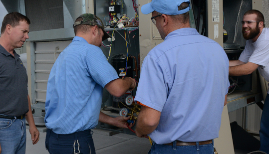 foreperson working on hvac unit