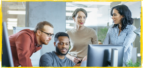 people collaborating around a computer